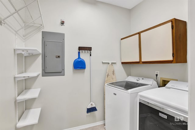 laundry room with cabinets, electric panel, and washer and dryer