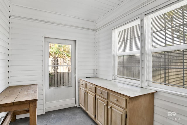 entryway with wood walls