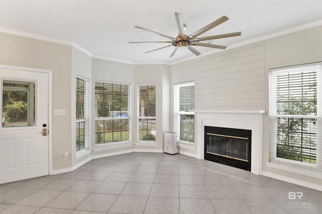 unfurnished living room featuring ceiling fan, light tile patterned floors, and ornamental molding