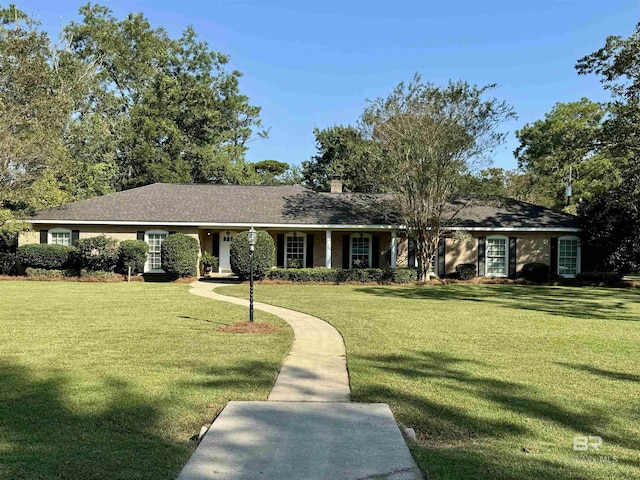 ranch-style home featuring a front yard