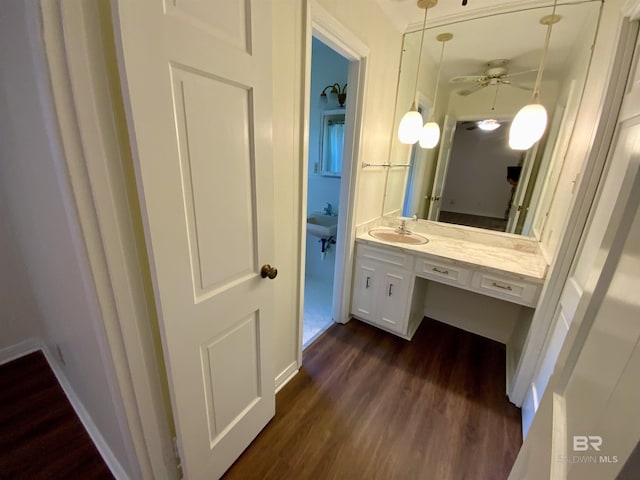 bathroom with ceiling fan, wood-type flooring, and sink