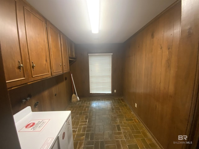 washroom with cabinets and wooden walls