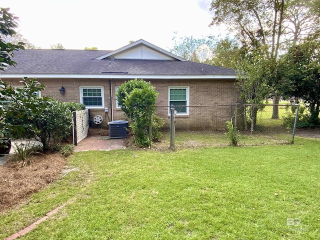 rear view of property with a yard