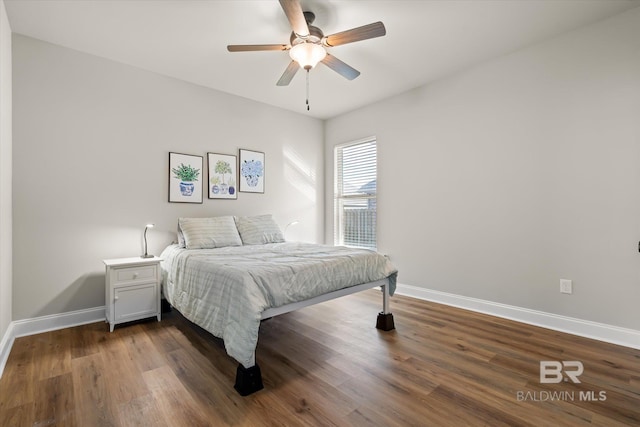 bedroom featuring ceiling fan and dark hardwood / wood-style floors