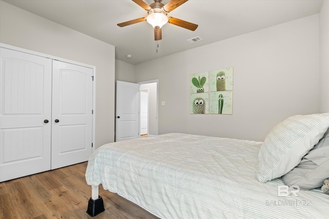 bedroom with a closet, ceiling fan, and wood-type flooring