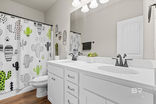 bathroom with curtained shower, hardwood / wood-style floors, vanity, and toilet