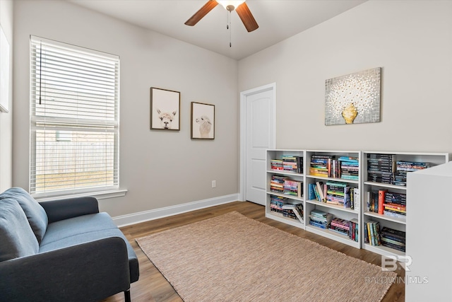 living area featuring ceiling fan and hardwood / wood-style floors