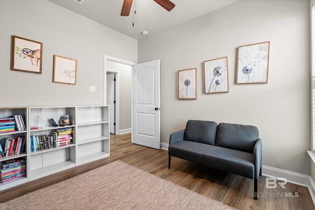 sitting room with ceiling fan and hardwood / wood-style floors