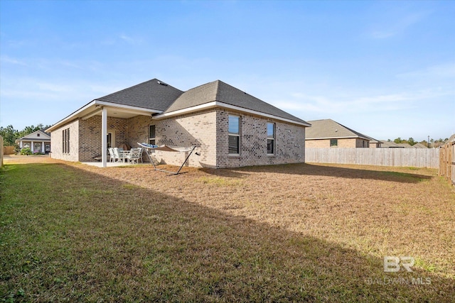 back of property featuring a yard and a patio area