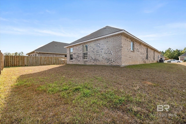 rear view of house featuring a lawn