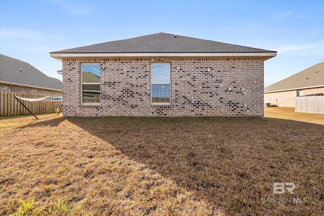 back of property featuring a lawn