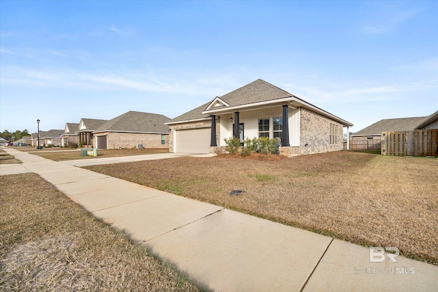 single story home featuring a front lawn and a garage