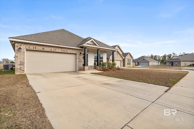 view of front of house featuring central air condition unit, a front lawn, a garage, and a porch