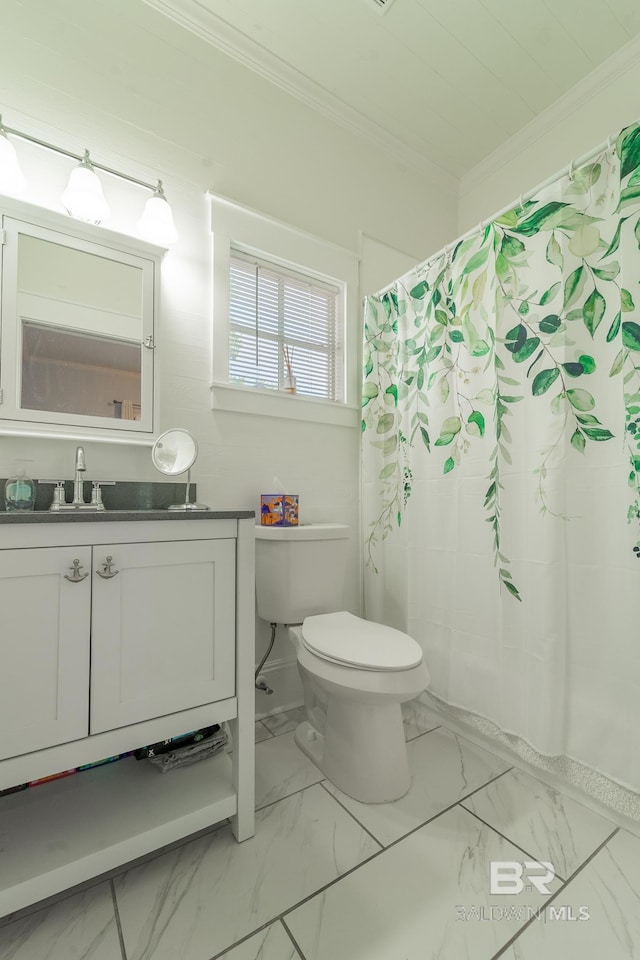 bathroom with toilet, tile patterned floors, ornamental molding, and vanity