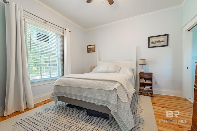 bedroom featuring ceiling fan, light hardwood / wood-style floors, and ornamental molding