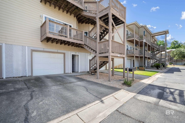 4 Yacht Club Dr, Daphne, AL 36526 - view of building exterior with an attached garage, stairs, and asphalt driveway