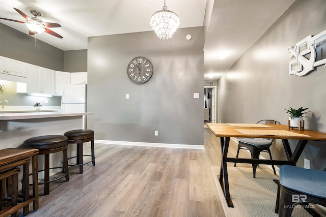 4 Yacht Club Dr, Daphne, AL 36526 - kitchen with freestanding refrigerator, light wood finished floors, a ceiling fan, white cabinets, and light countertops