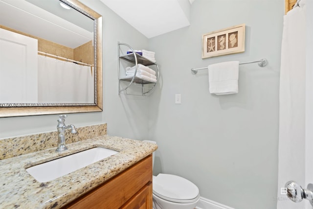 23044 Perdido Beach Blvd Unit 141, Orange Beach, AL 36561 - bathroom with toilet, vanity, a shower with shower curtain, and baseboards