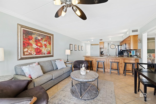 23044 Perdido Beach Blvd Unit 141, Orange Beach, AL 36561 - living area featuring light tile patterned flooring, ornamental molding, and a ceiling fan
