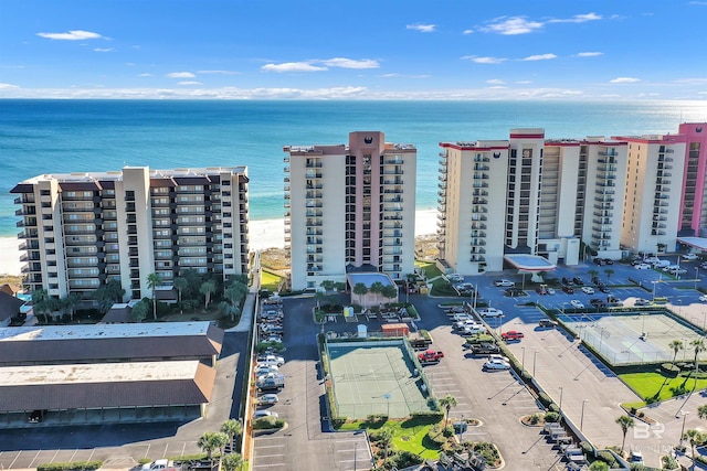 bird's eye view featuring a water view and a beach view