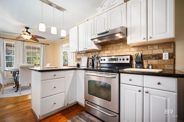 kitchen featuring stainless steel range with electric cooktop, dark hardwood / wood-style flooring, kitchen peninsula, and white cabinetry