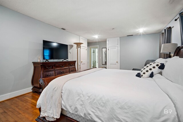 bedroom with hardwood / wood-style floors