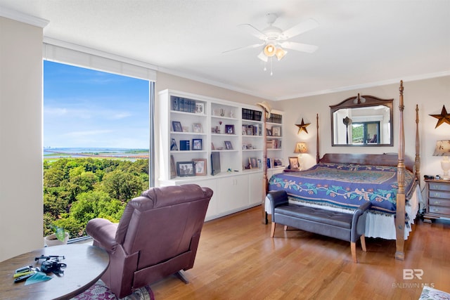 bedroom featuring a wall of windows, ceiling fan, light hardwood / wood-style floors, and ornamental molding