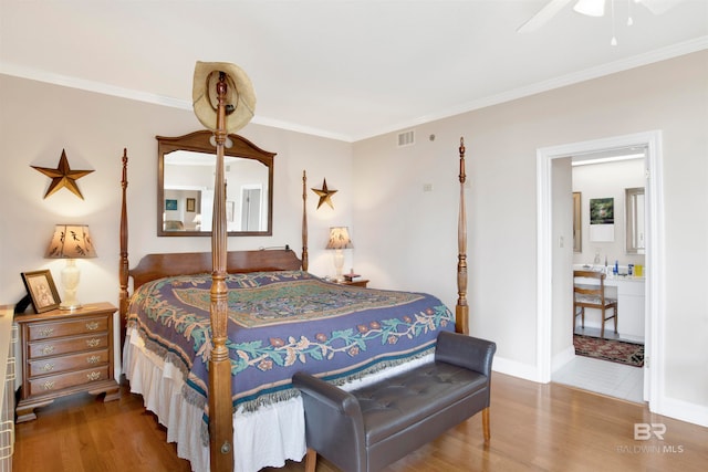 tiled bedroom featuring ornamental molding, ceiling fan, and ensuite bathroom