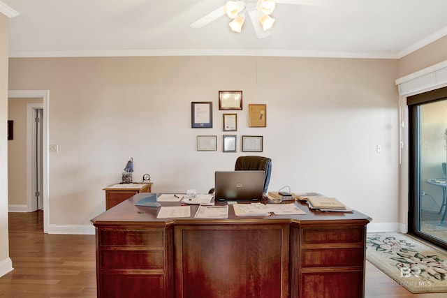 office space with ornamental molding, plenty of natural light, dark hardwood / wood-style flooring, and ceiling fan