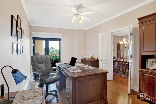 office area with ceiling fan with notable chandelier, crown molding, light hardwood / wood-style flooring, and french doors