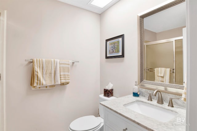 bathroom with toilet and large vanity