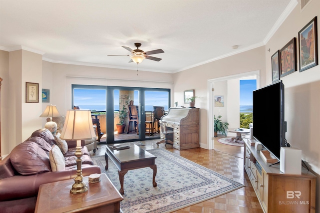 living room featuring ornamental molding, plenty of natural light, and light parquet flooring