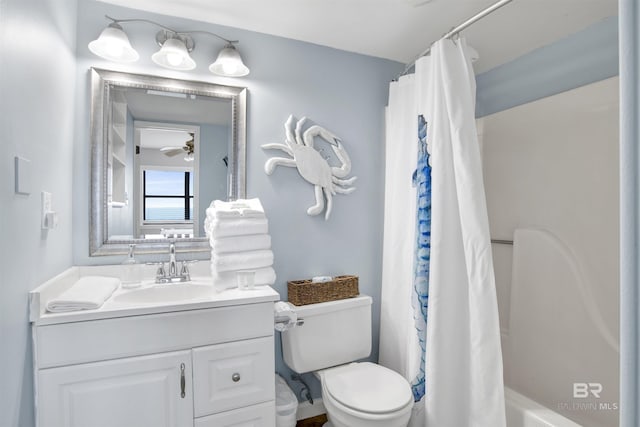 bathroom featuring toilet, ceiling fan, and vanity