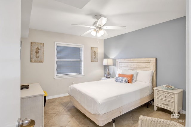 bedroom with ceiling fan, light tile patterned flooring, and baseboards