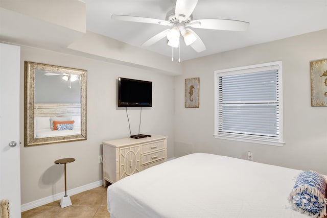 bedroom with light tile patterned floors, ceiling fan, and baseboards