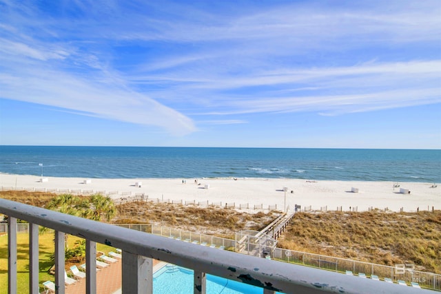 property view of water featuring a view of the beach and fence