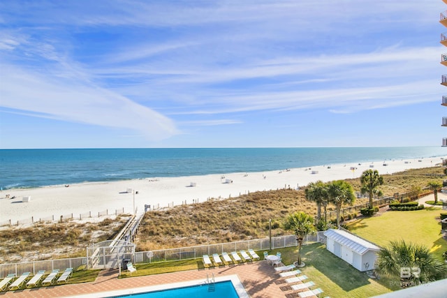 property view of water with fence and a view of the beach