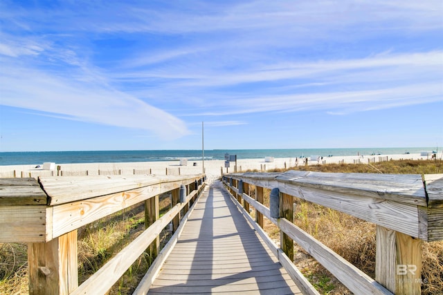 view of home's community featuring a beach view and a water view