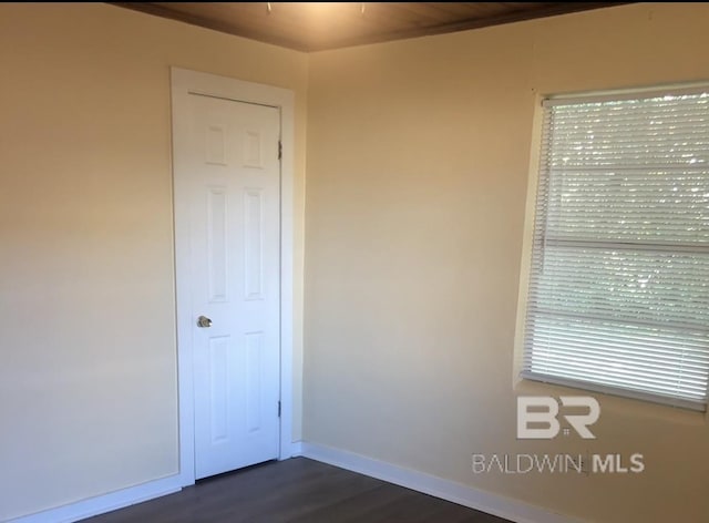 empty room featuring dark hardwood / wood-style flooring