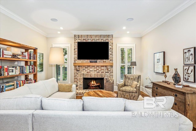 living area featuring ornamental molding, a brick fireplace, wood finished floors, recessed lighting, and baseboards