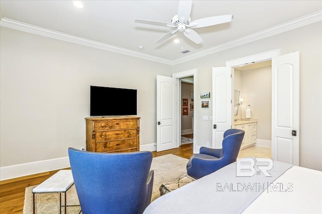 bedroom with crown molding, baseboards, ceiling fan, wood finished floors, and connected bathroom