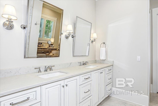 bathroom with double vanity and marble finish floors