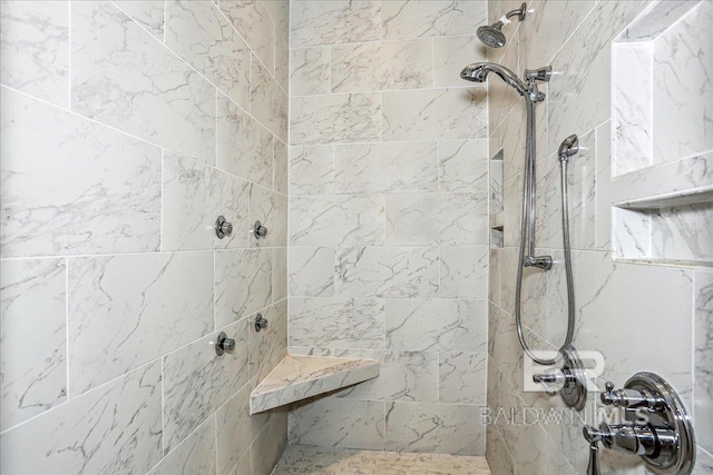 full bath featuring a tile shower