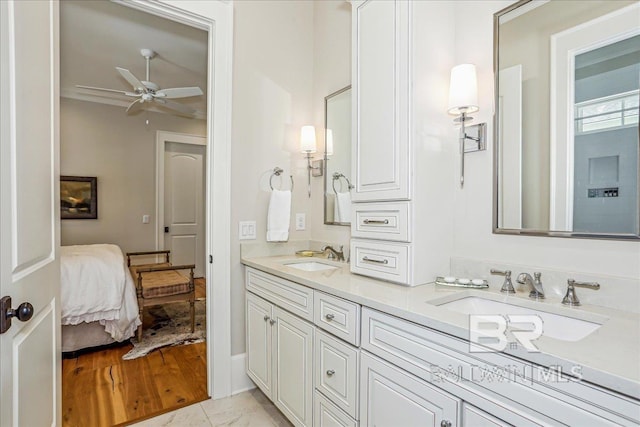 bathroom with ceiling fan, double vanity, and ensuite bathroom