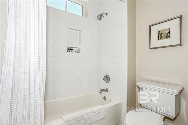 bathroom with shower / tub combo with curtain and toilet