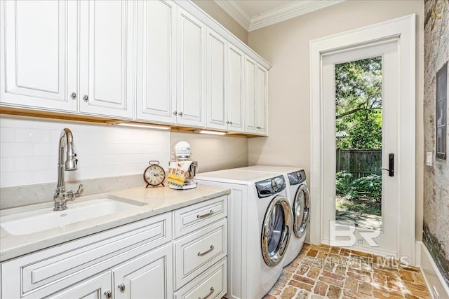laundry room featuring cabinet space, ornamental molding, brick floors, and independent washer and dryer