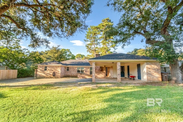 back of property featuring a lawn