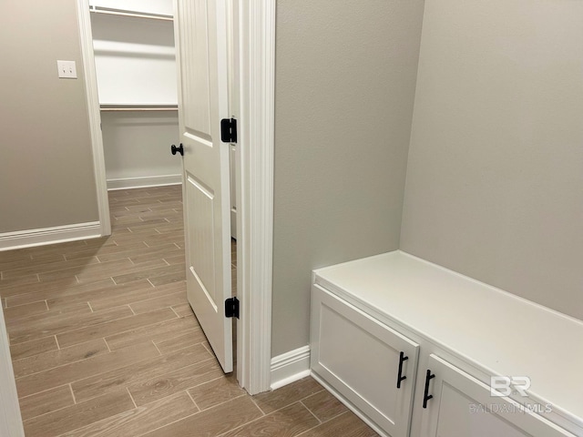 interior space with baseboards and wood finish floors