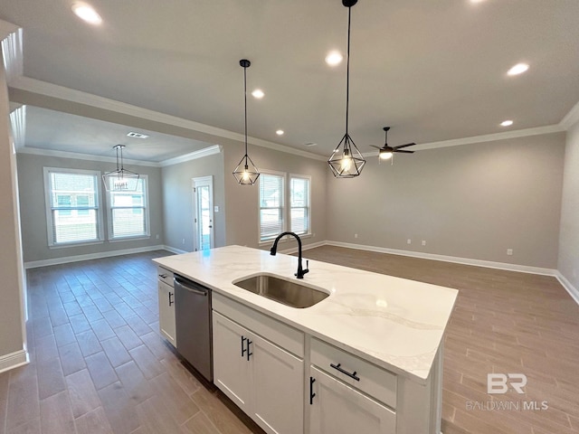 kitchen featuring a sink, wood finished floors, open floor plan, and stainless steel dishwasher