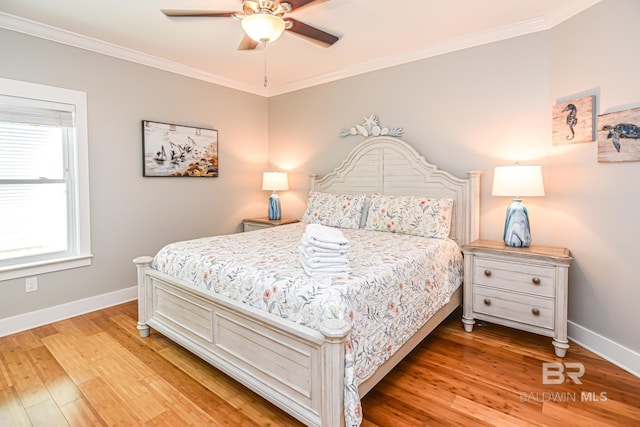 bedroom with light wood finished floors, ceiling fan, baseboards, and crown molding